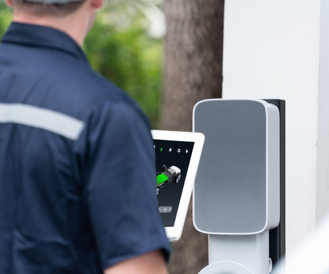 Qualified technician install home EV charging station. Synchronos